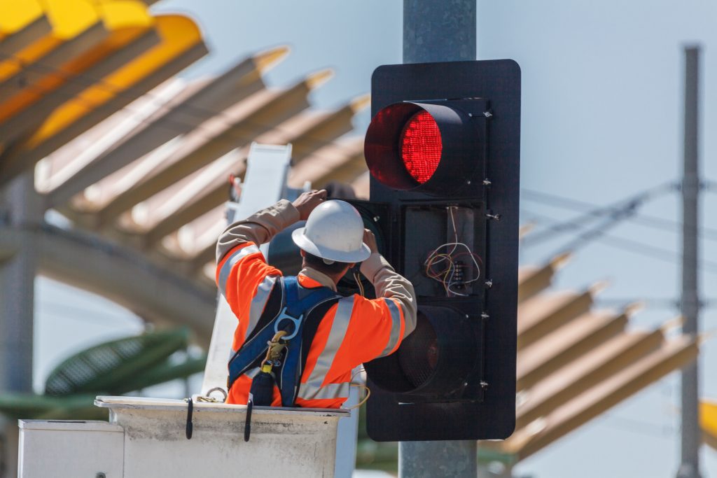 photo of a technician fixing a traffic light